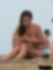 Sexy babe with a nice body topless and in a thong on the beach