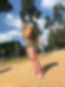 Cute Barefoot Candid Girl in Shorts and a Top Smoking at the Beach