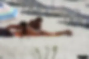 Topless milf and her topless daughter on the beach