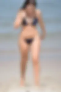 Blue bikini girl on the beach with a great ass and a little pussy lips slips