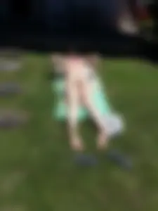Girl in Swimsuit with White Skin Lying on the Grass in the Backyard