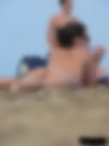 Sexy babe with a nice body topless and in a thong on the beach