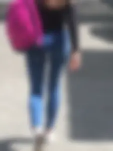 Girl in Tight Jeans Walking Down the City Park Candid