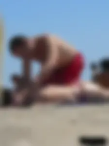 Purple thong topless lady on the beach gets oiled up by her husband