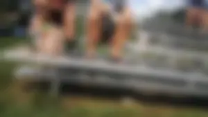 Girl in Shorts And Slippers Sitting With Spread Legs at a Street Sporting Ground Creepshot - Her Crotch Clearly Visible