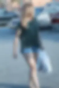 Cutie walking in the parking lot in jean shorts