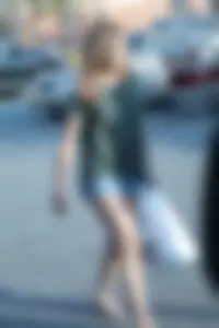 Cutie walking in the parking lot in jean shorts