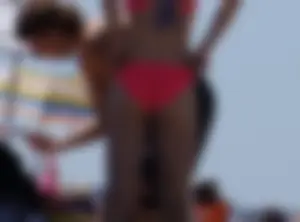 Sexy and skinny girl on the beach in pink bikini