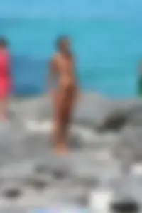Older lady on a nude beach showing her body