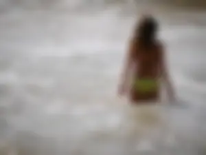 Sexy girl in yellow and black bikini on the beach