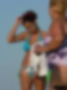 A bunch of hot babes on the beach in thong bikinis