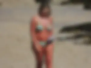 Blonde milf on the beach in her bikini