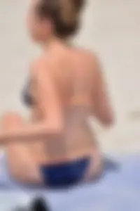 Blue bikini girl on the beach with a great ass and a little pussy lips slips