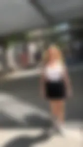 Gorgeous blonde college girl in a skirt passing by