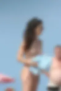 2 topless girls at the beach in thongs