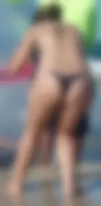 Milf on the beach in a thong bikini