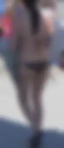 Girl in a tiny brown floral bikini showing some cheek and crack
