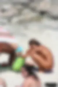 Older lady on a nude beach showing her body