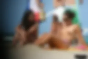 2 topless girls at the beach in thongs