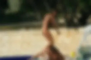 Two sexy nude beach friends getting some sun