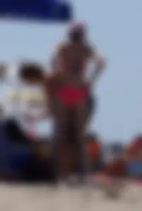 Sexy and skinny girl on the beach in pink bikini
