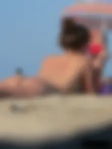 Sexy babe with a nice body topless and in a thong on the beach