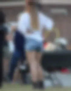 Hippie type dressed girl in denim shorts with a nice ass