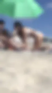 Friends on the beach in bikinis and flashing