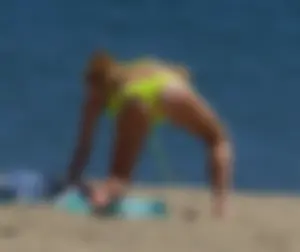 Sexy ass blonde milf on the beach in a thong with cameltoe and bending over
