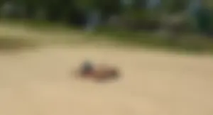 Sexy girl getting some sun laying on the beach in thong bikini
