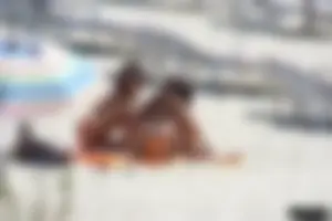Topless milf and her topless daughter on the beach