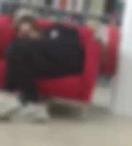 Candid girl chilling on a couch in a public library creepshots