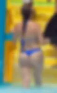 Milf at the pool in a thong bikini with big boobs looking hot