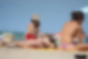 2 topless girls at the beach in thongs