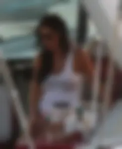 Bikini babe on a boat with a wet see through white shirt showing her tits