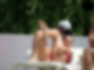 Smoking brunette in pink thong at the pool with camel toe
