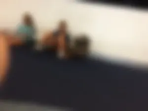 Girl in Sneakers Sitting With Spread Legs on the Floor