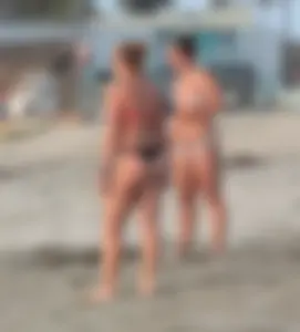 Thick white girls ass in a black thong bikini at the beach