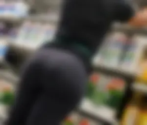 Somalian dollar store employee stocking inventory