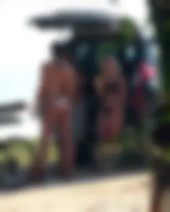 A sexy brunette and sexy blonde in bikinis at the beach