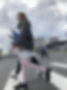 Candid teen girl wearing a skirt and white pantyhose crossing the street creepshots