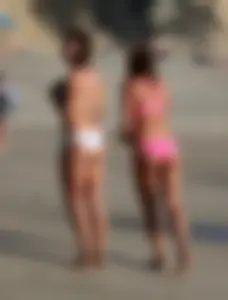 Two sexy friends out on the beach in bikinis