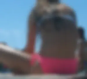 Pink bikini bottom girl laying in the sun up close
