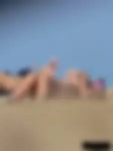 Sexy babe with a nice body topless and in a thong on the beach