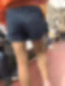 Subway Candid Girl in Denim Shorts and Sneakers Sitting With Crossed Legs in the Train