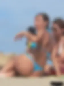 Sexy lady on the beach in a blue thong bikini