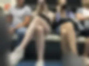 Tall Girl in Denim Mini Shorts and Sneakers With Long Pale Legs in a Subway Train