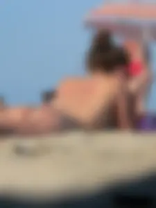 Sexy babe with a nice body topless and in a thong on the beach