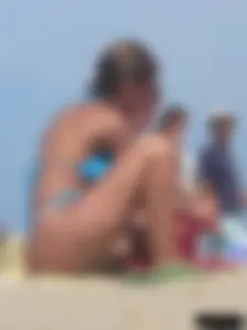 Sexy lady on the beach in a blue thong bikini