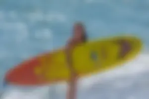 Candid girls surfing on the beach